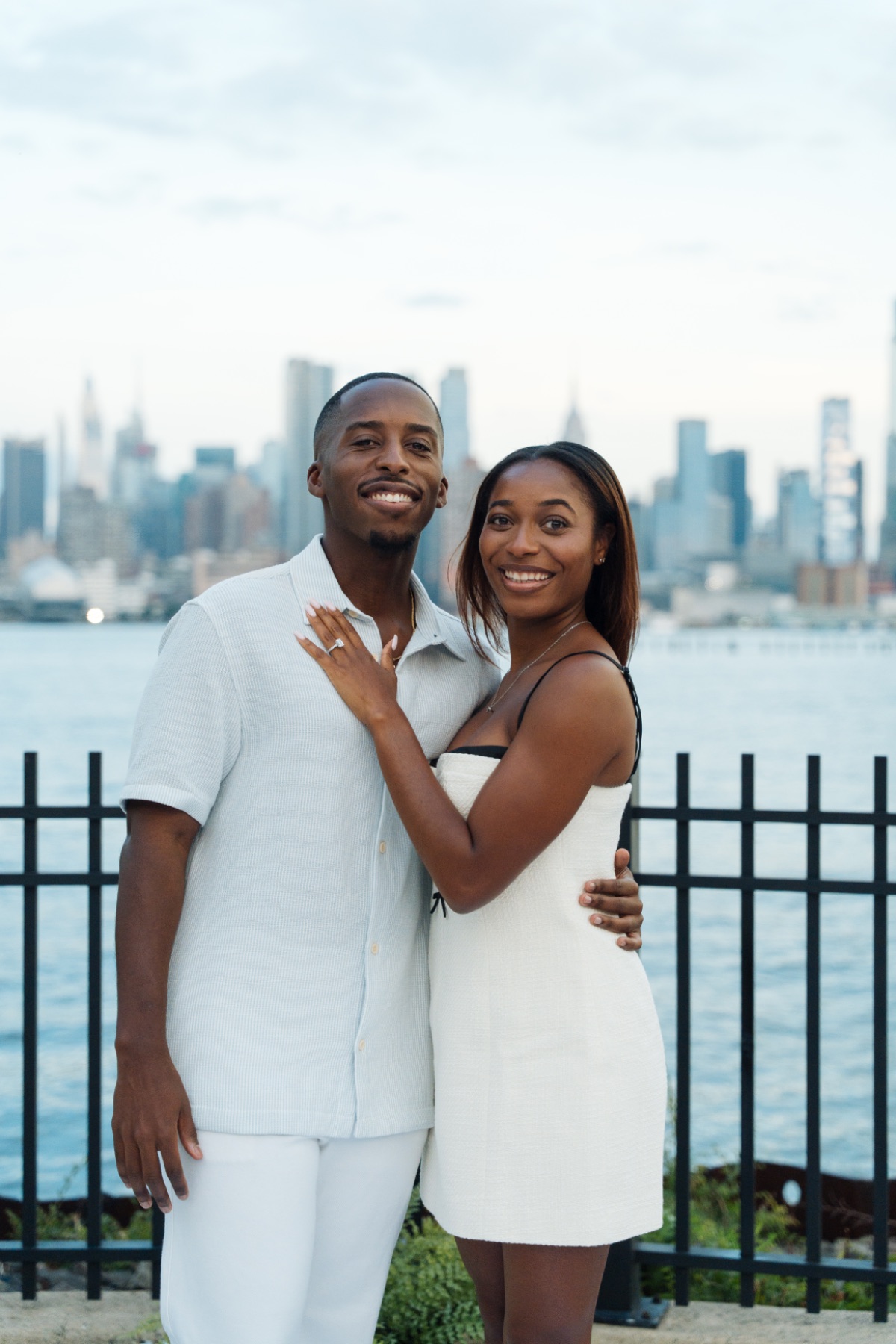 Engaged couple kissing by the river