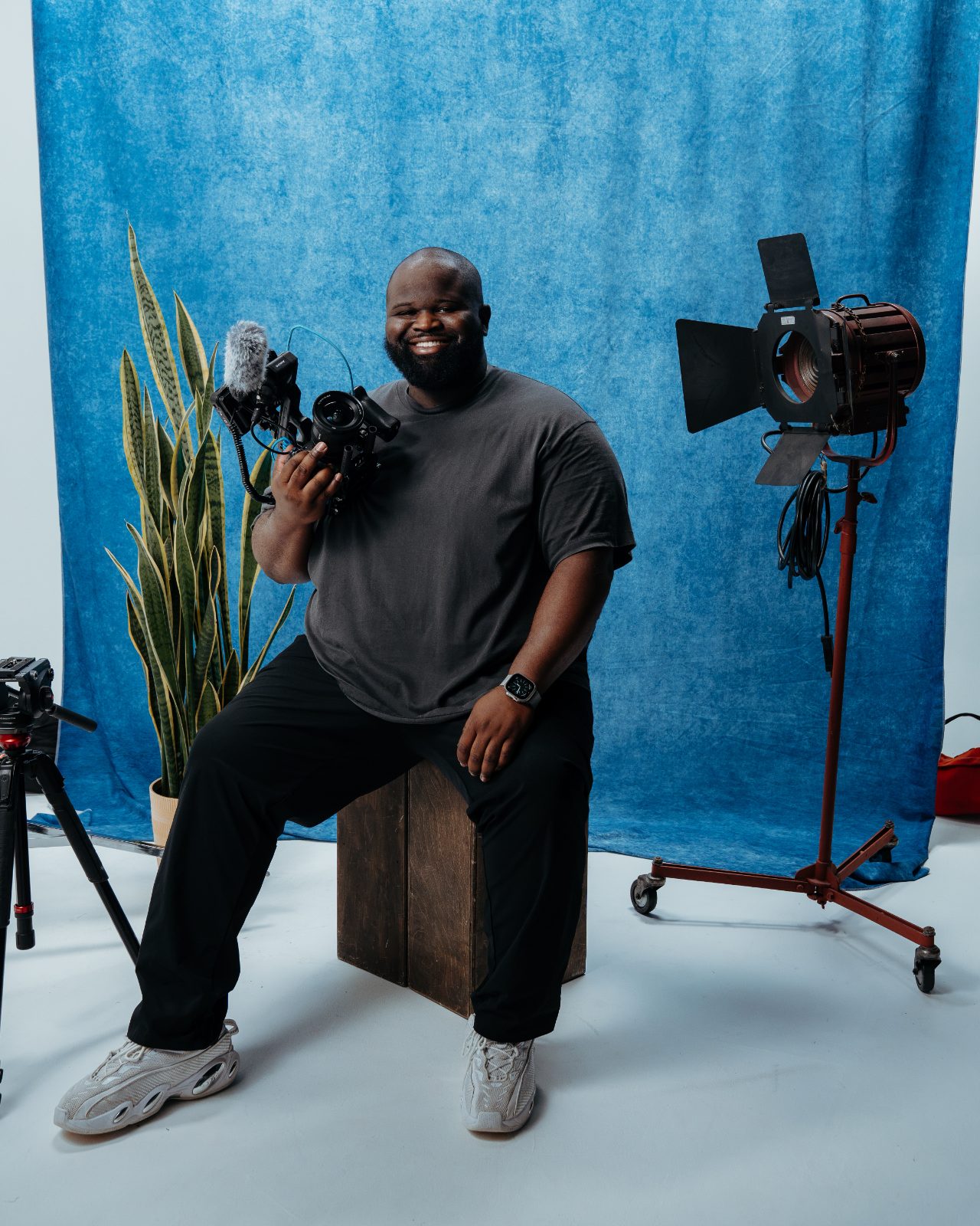 Fitzroy, wedding videographer and photographer, smiling with his cinema camera