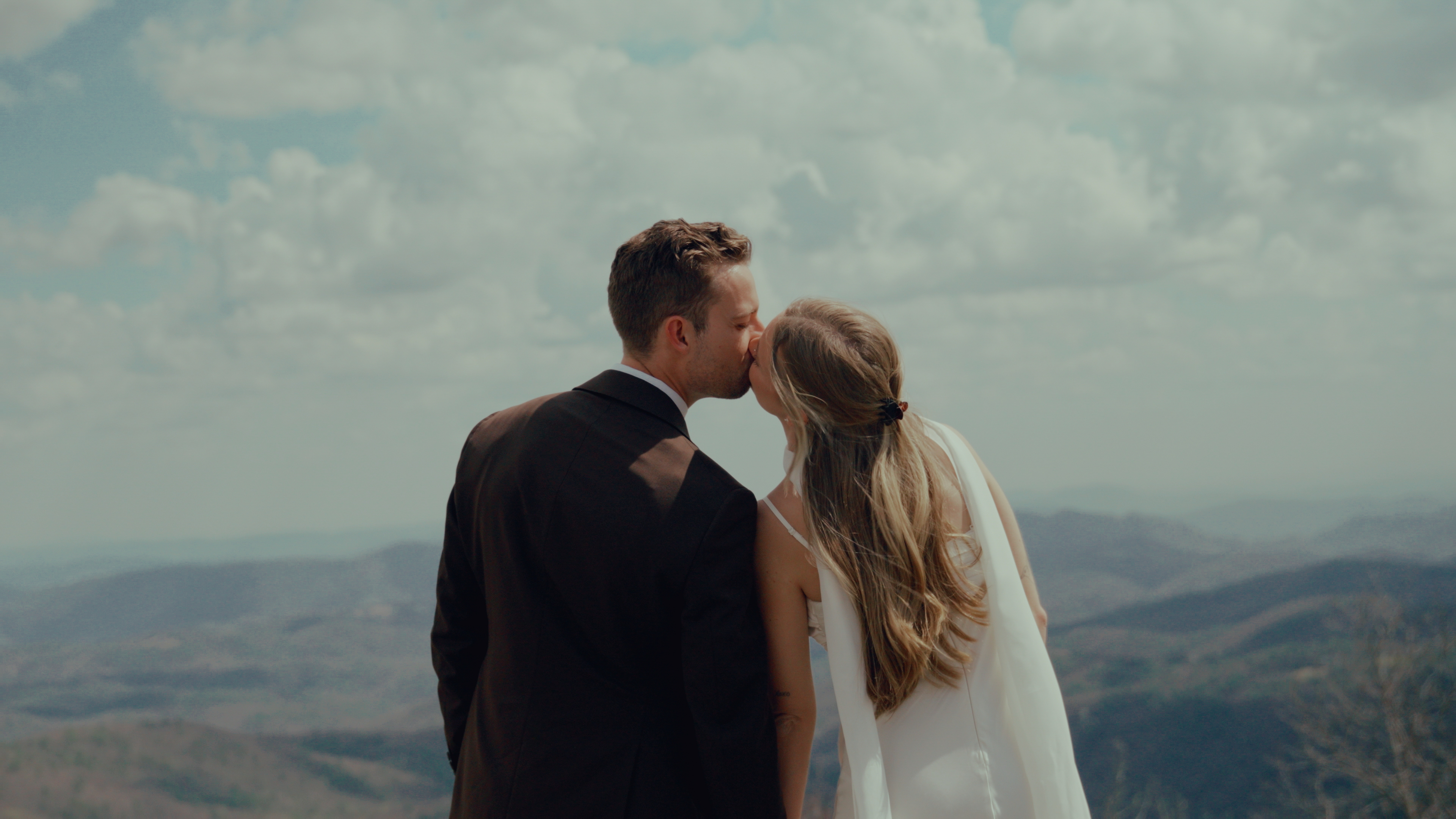 Couple kissing on a mountain overlook